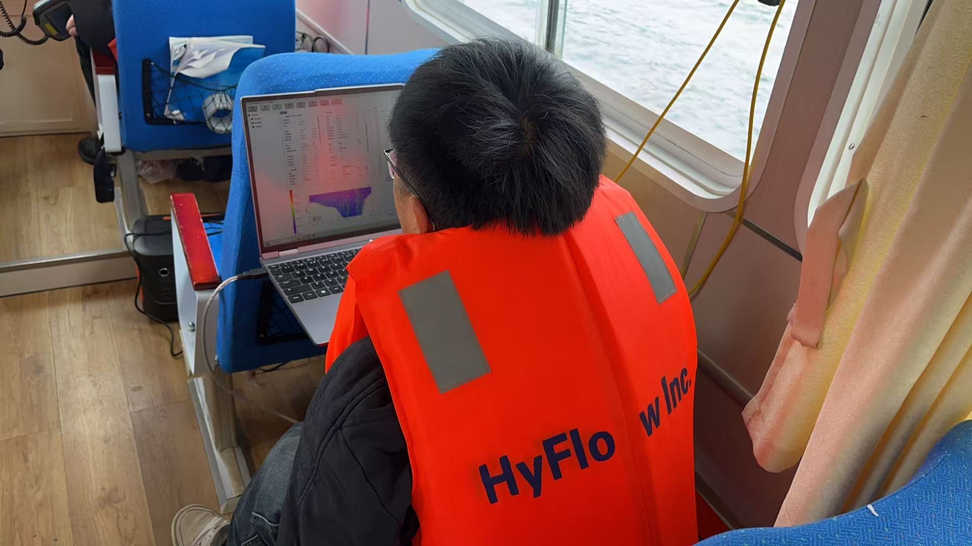 HyFlow engineer analyzing real-time velocity profiles on a survey vessel